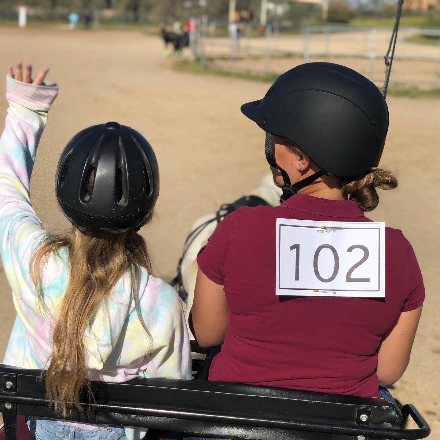 Picture of a student driving a horse